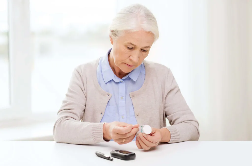 Older woman preparing diabetes testing supplies at home