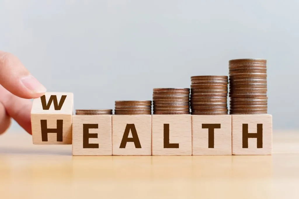 Healthcare and wellness financial concept with coins and blocks