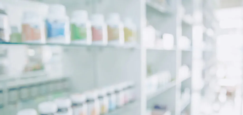 Blurred pharmacy shelves and medication storage background
