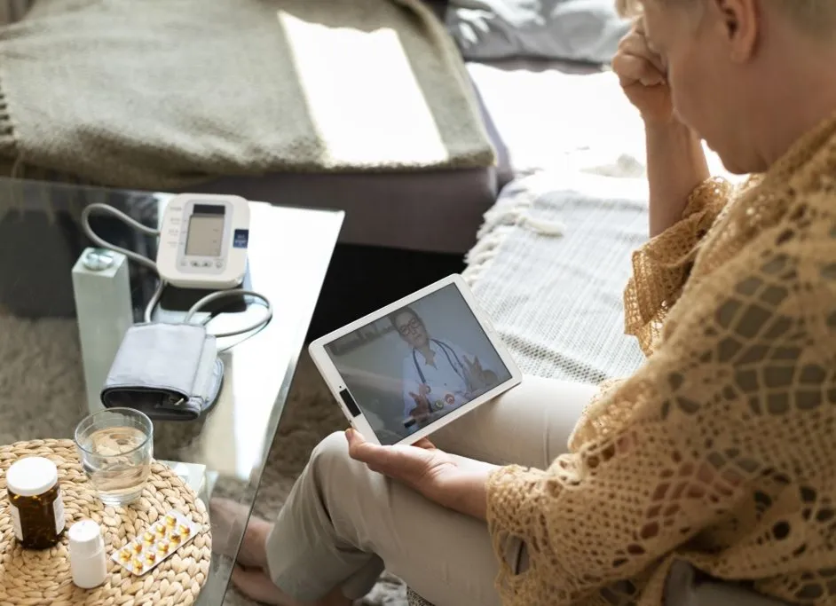 Senior woman attending telemedicine consultation on tablet from home