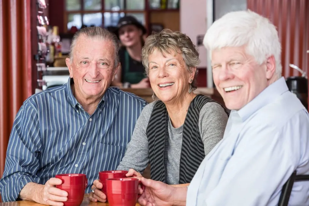 Senior adults enjoying social gathering with coffee and conversation