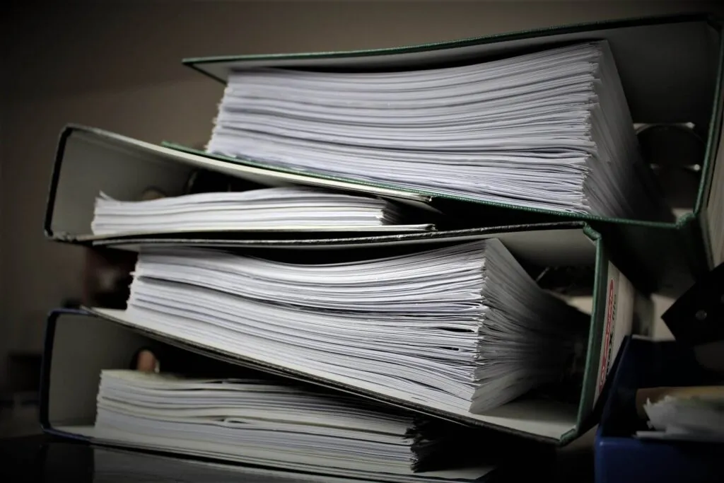 Stack of medical documents and healthcare paperwork in office