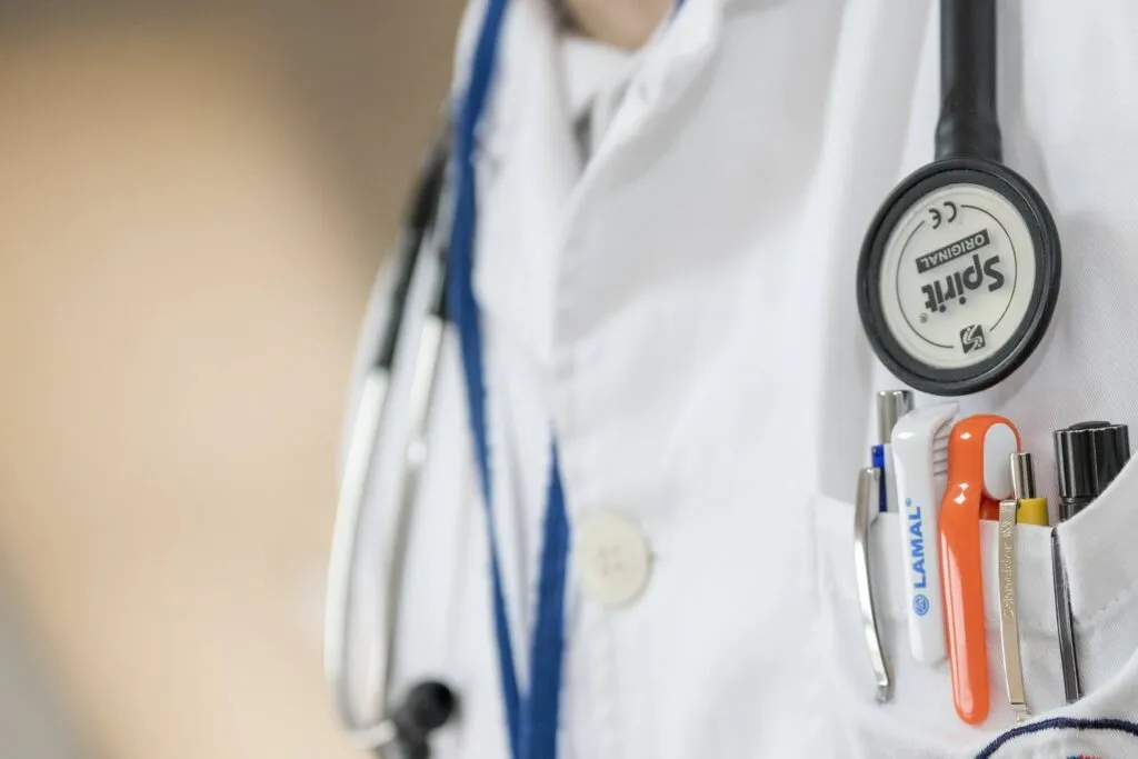 Close-up of doctor’s white coat with stethoscope and medical tools