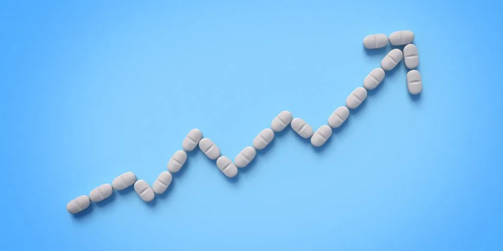 Rising healthcare costs or medication growth concept with pills forming upward graph