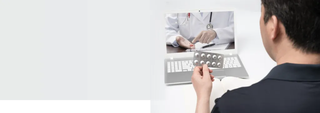 Patient holding medicine during online doctor consultation