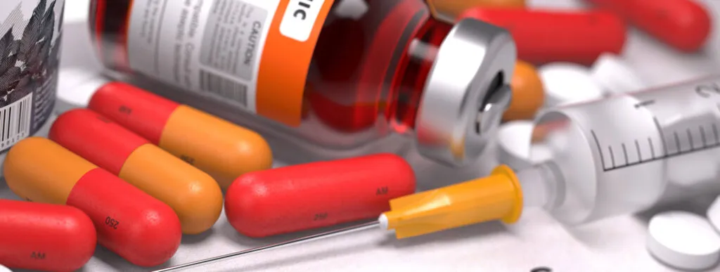 Medical syringe with prescription medications and healthcare treatment concept